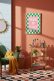 Playful 'Take It Easy' Quote Art Print shown framed in a modern room setting