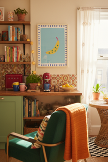 Playful Banana Illustration Art Print shown framed in a modern room setting