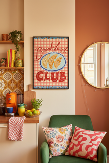 Playful Breakfast Club Art Print shown framed in a modern room setting