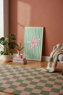 Playful Pink Starfish Art Print shown framed in a modern room setting